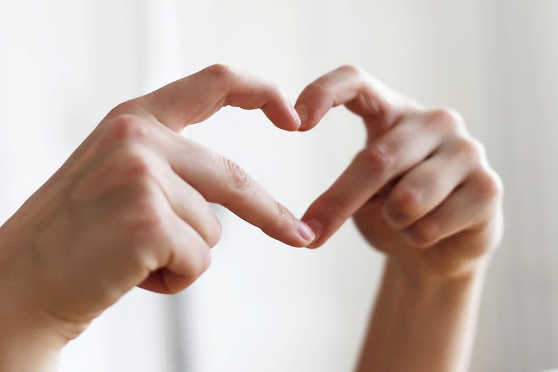 Woman showing heart symbol